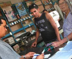 Cubanos compran en bodega estatal con libreta de racionamiento